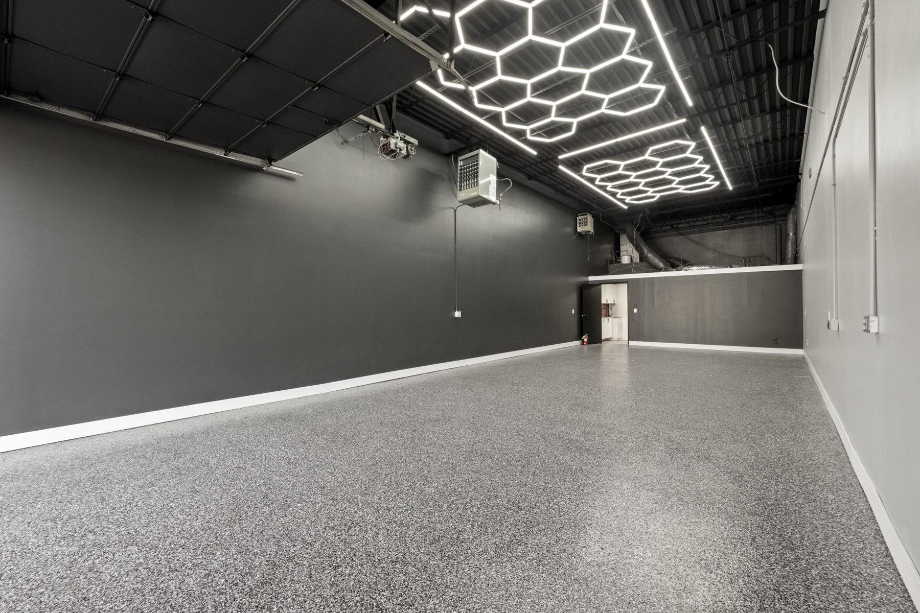Empty warehouse suite with overhead door raised for loading