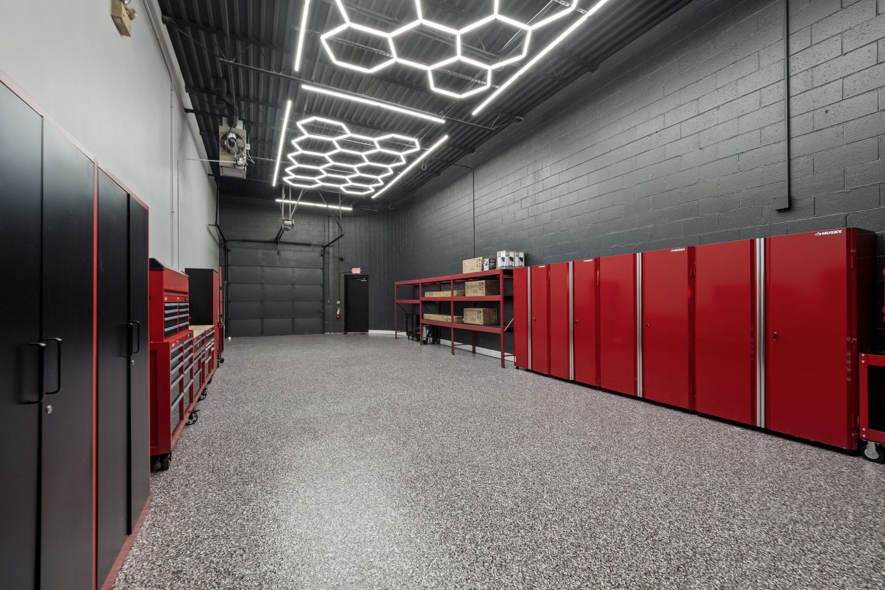 High-ceiling warehouse suite with red storage cabinets and LED hex lighting