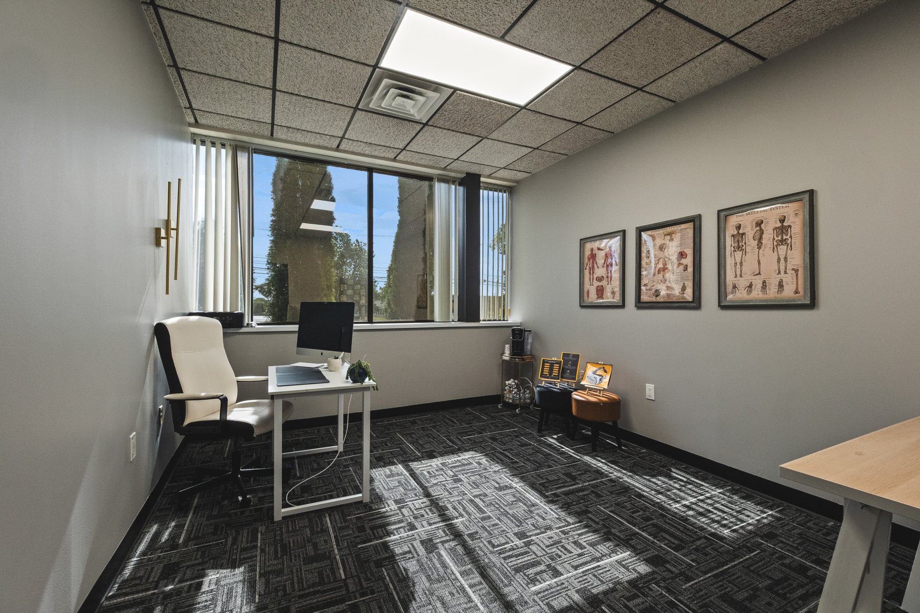 Private window office with desk, natural light and carpet