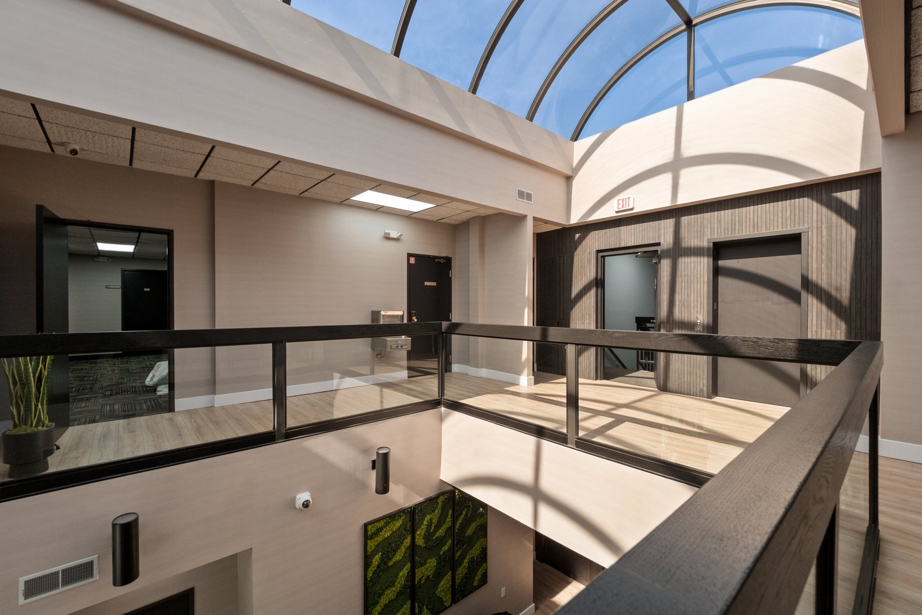 Second-floor balcony overlooking the lobby, with ceiling-mounted security cameras