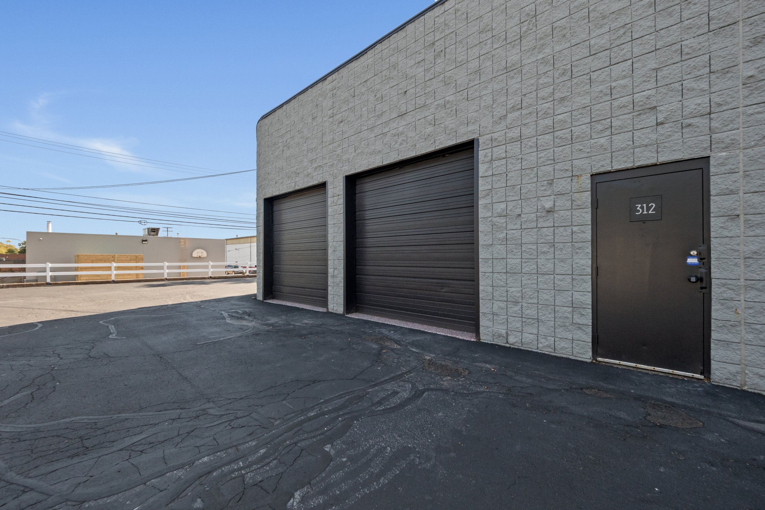 Two black overhead drive-in doors and a numbered service door on a warehouse suite at Z Novi Commons