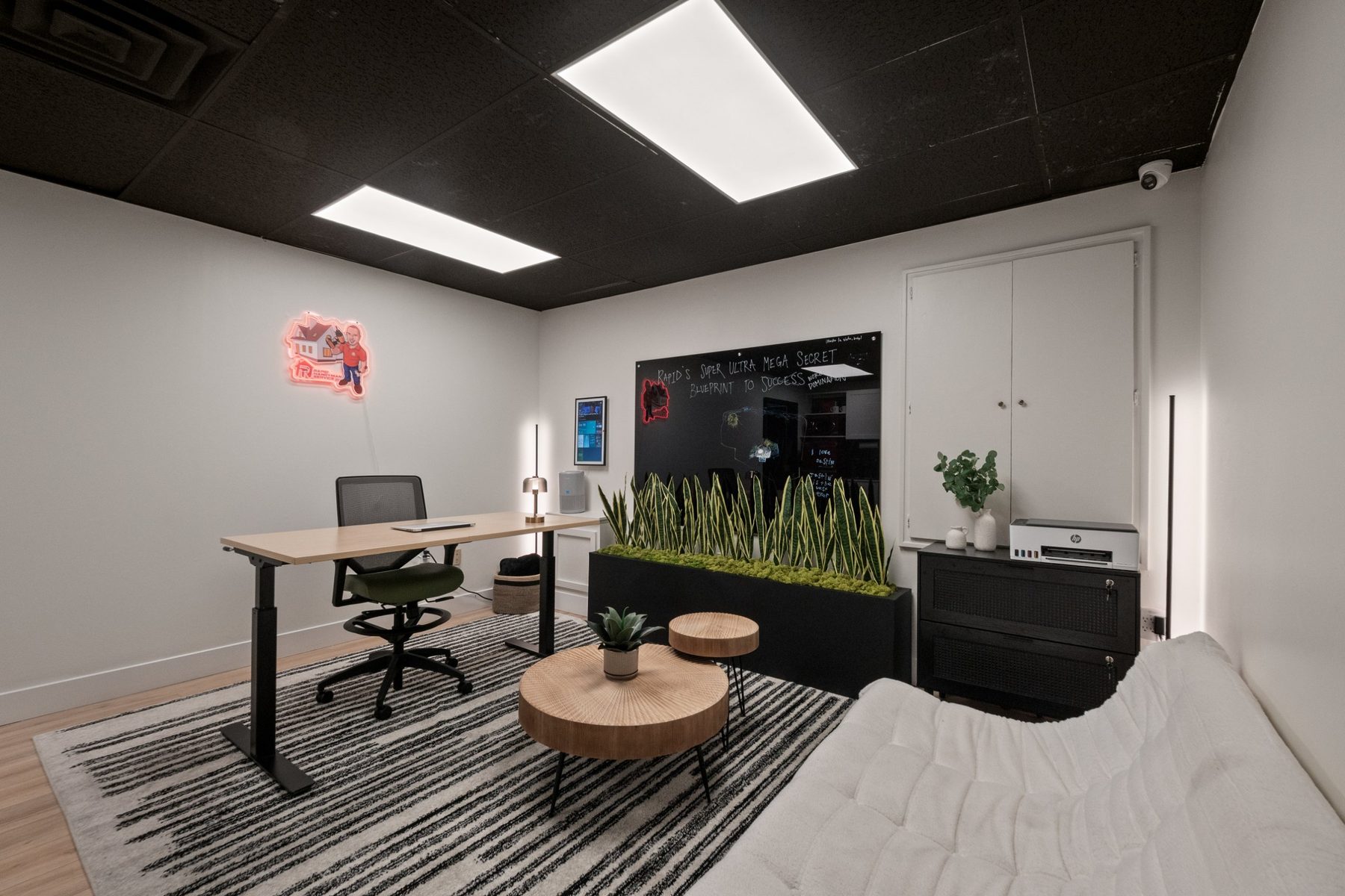 Warehouse suite office with desk, seating area, storage cabinets and glass board