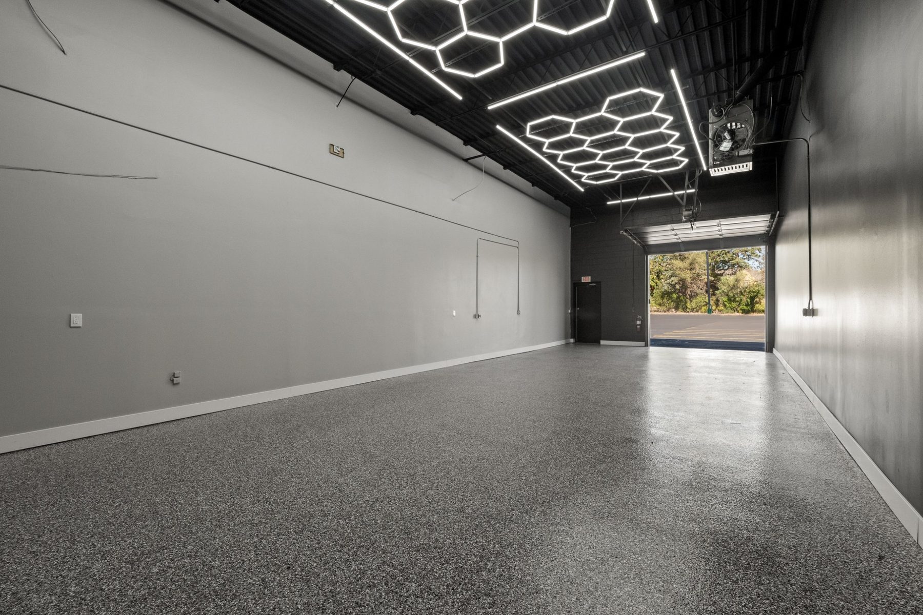 Warehouse suite with drive-in door open and LED hex lighting