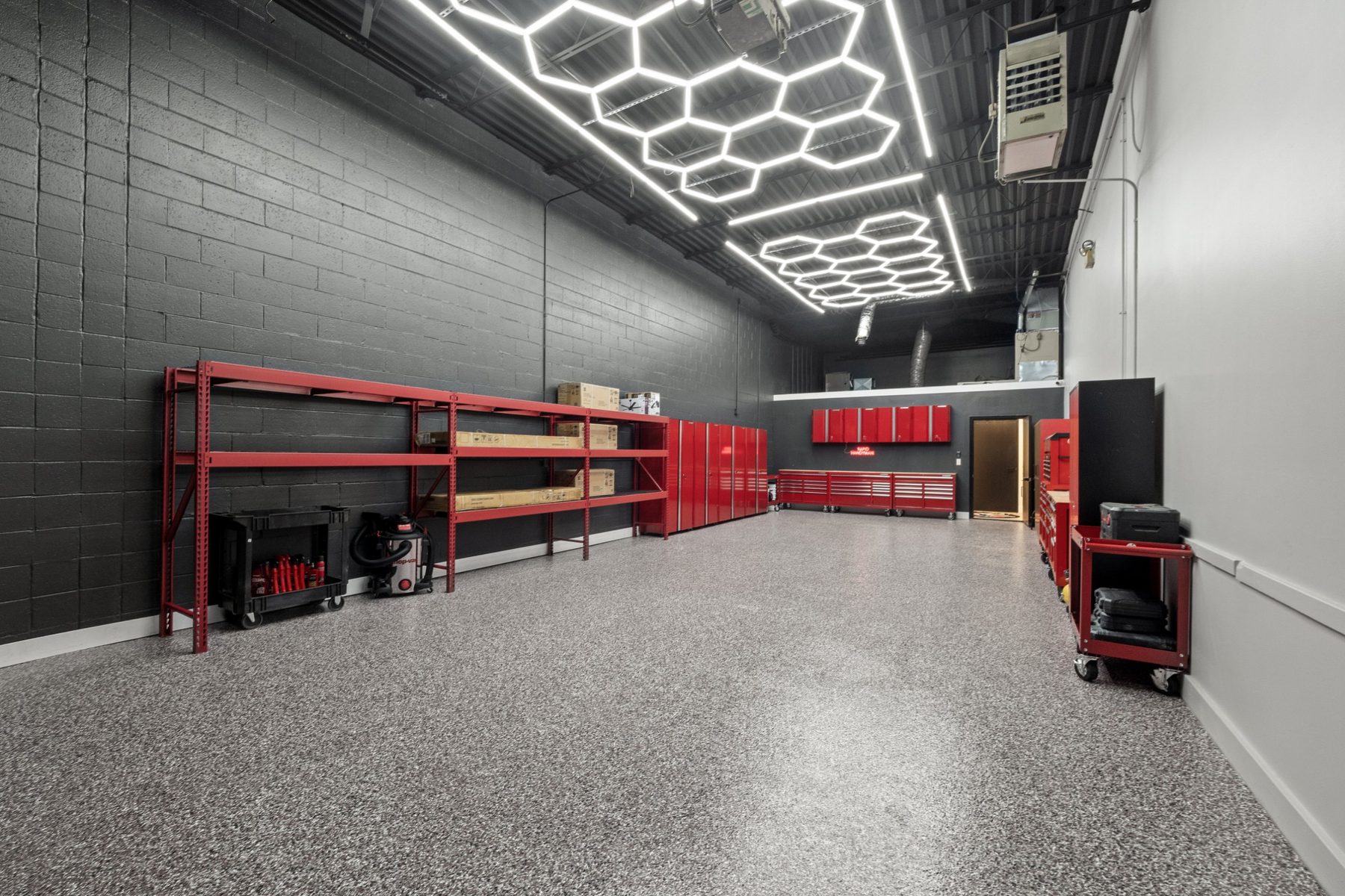 Warehouse suite with red shelving, tool storage and LED hex lighting